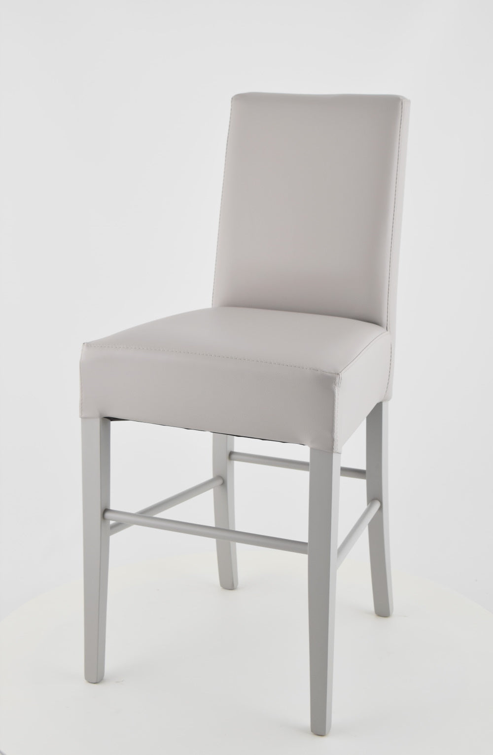 Luisa low stools in beech wood structure, padded seat and backrest covered in artificial leather