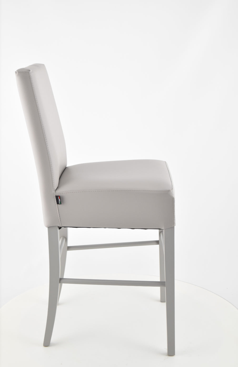 Luisa low stools in beech wood structure, padded seat and backrest covered in artificial leather