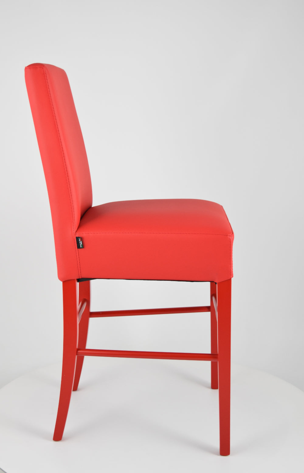 Luisa low stools in beech wood structure, padded seat and backrest covered in artificial leather