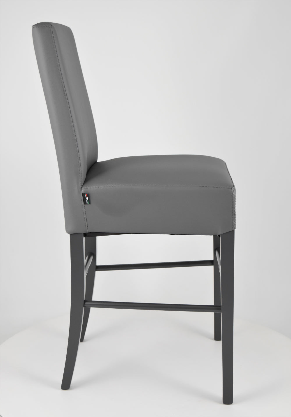 Luisa low stools in beech wood structure, padded seat and backrest covered in artificial leather