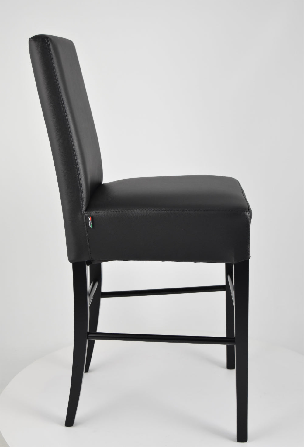 Luisa low stools in beech wood structure, padded seat and backrest covered in artificial leather