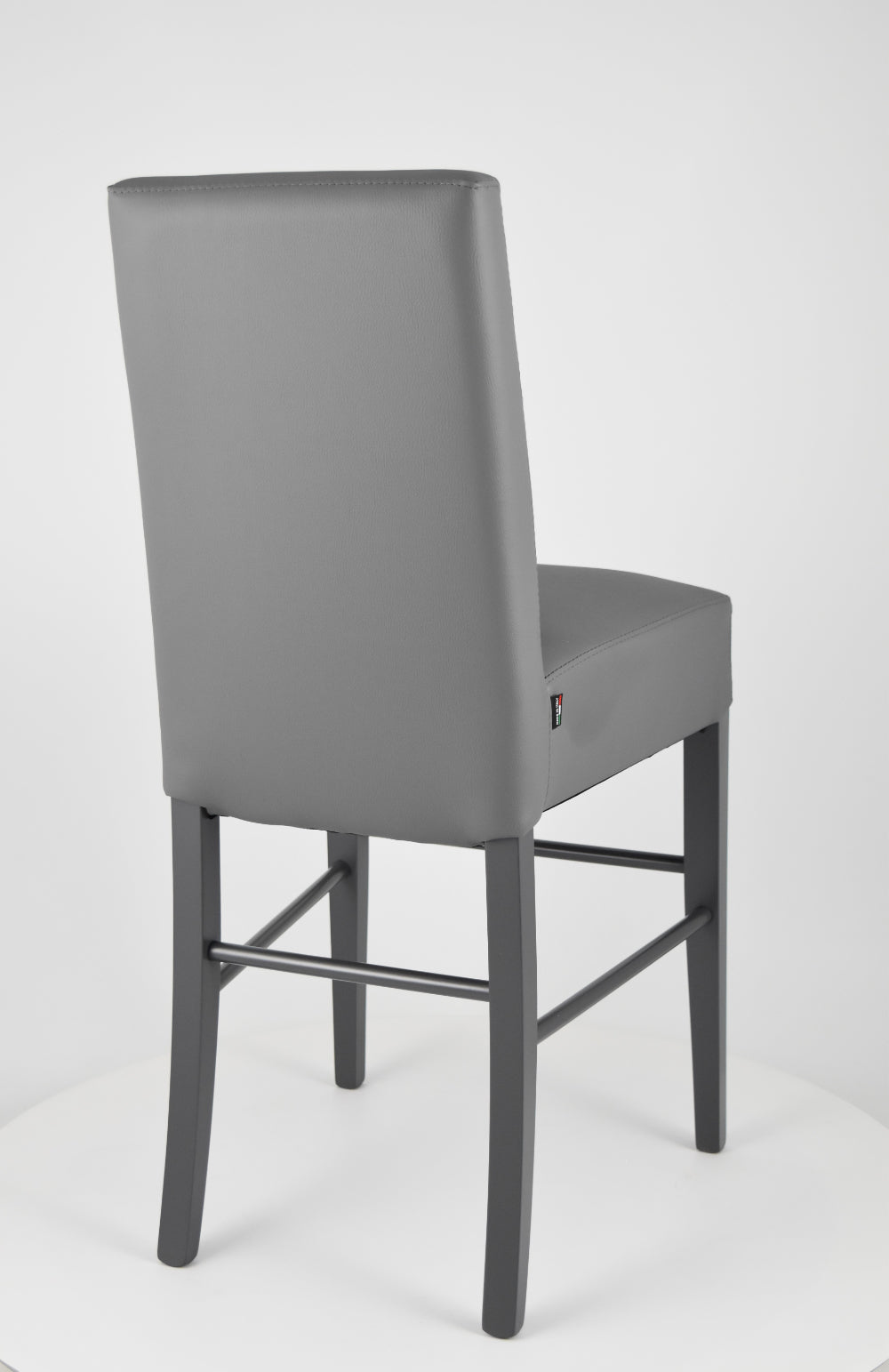 Luisa low stools in beech wood structure, padded seat and backrest covered in artificial leather