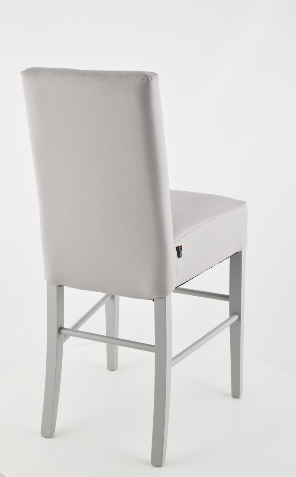 Luisa low stools in beech wood structure, padded seat and backrest covered in artificial leather