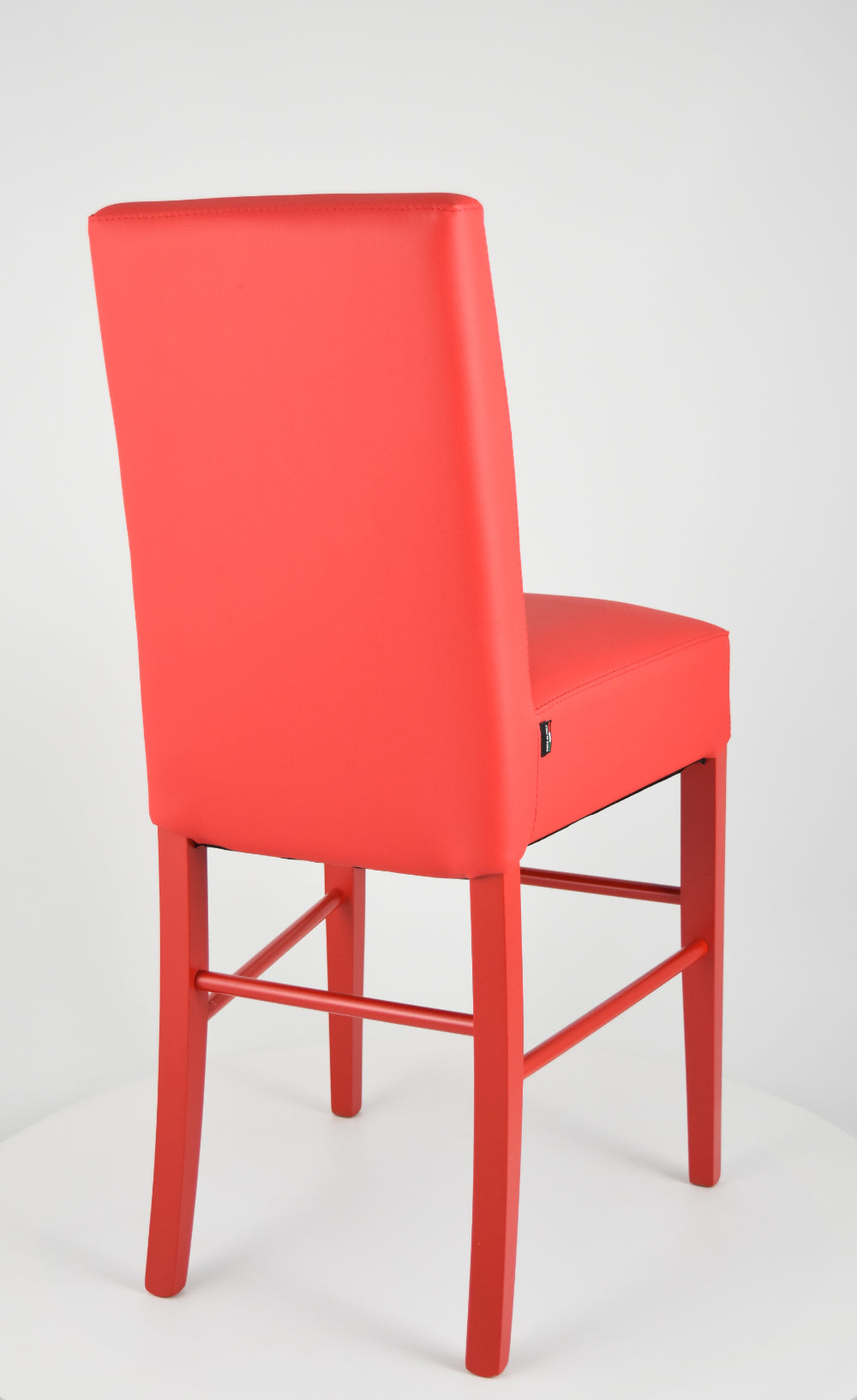Luisa low stools in beech wood structure, padded seat and backrest covered in artificial leather