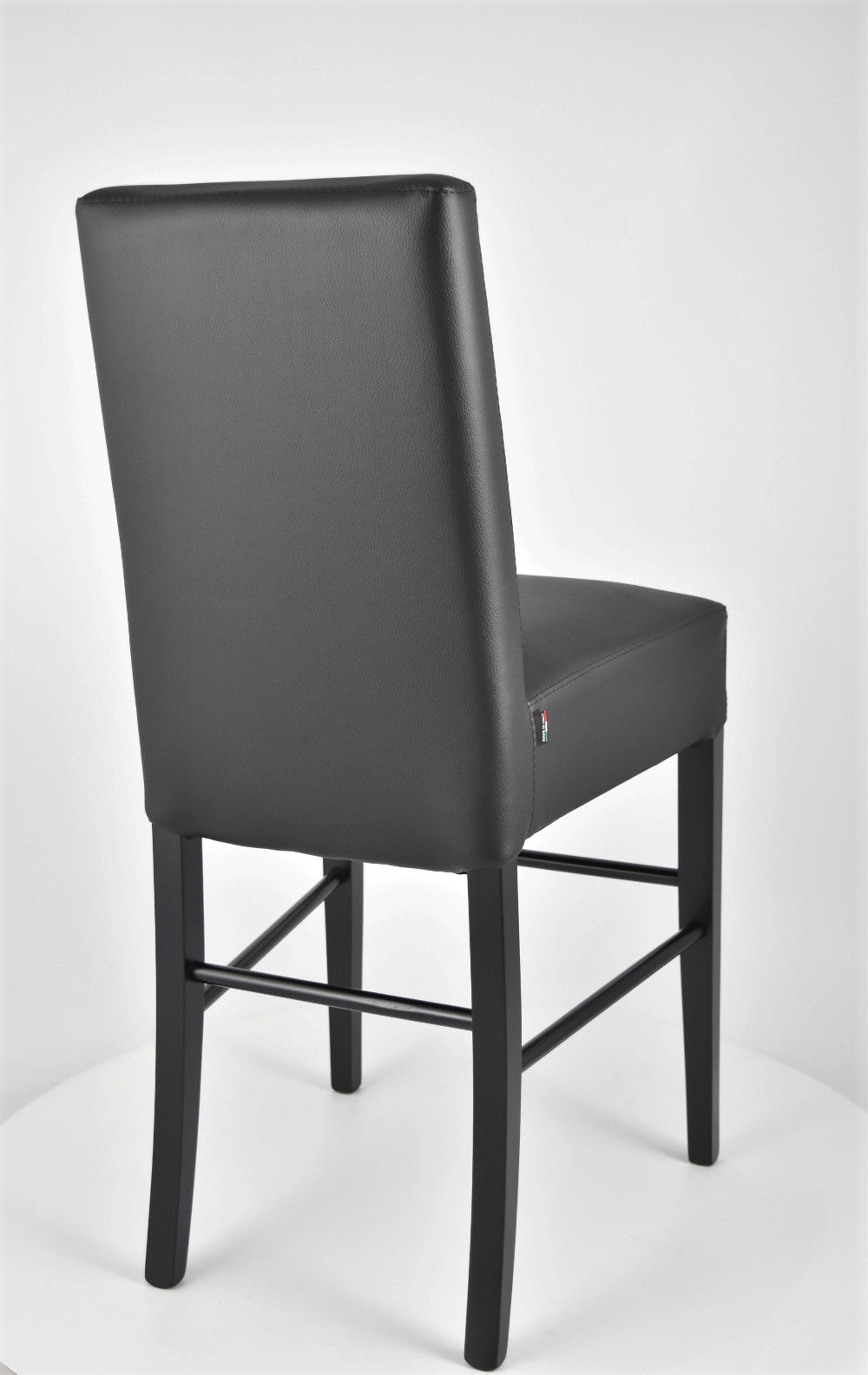 Luisa low stools in beech wood structure, padded seat and backrest covered in artificial leather