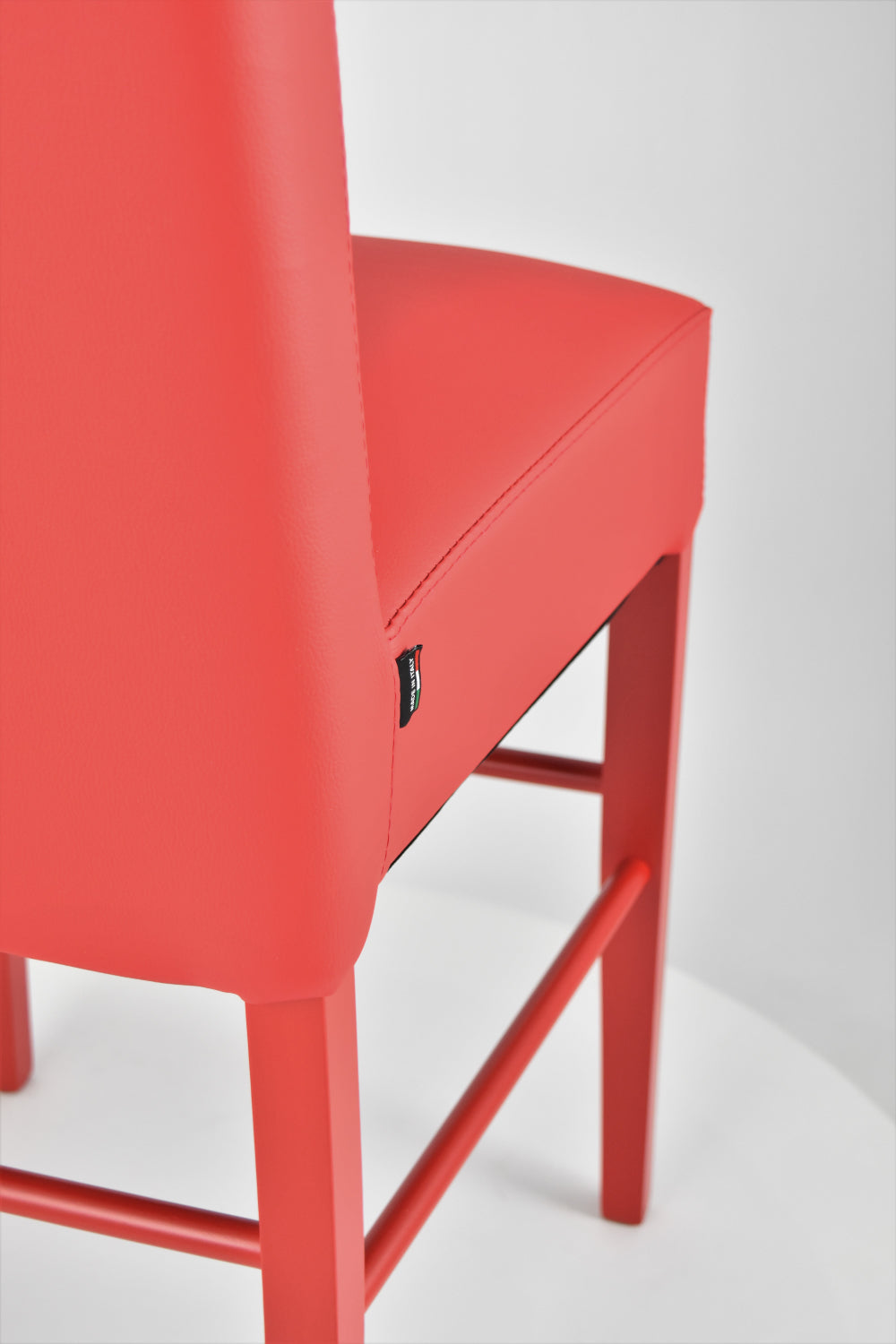 Luisa low stools in beech wood structure, padded seat and backrest covered in artificial leather