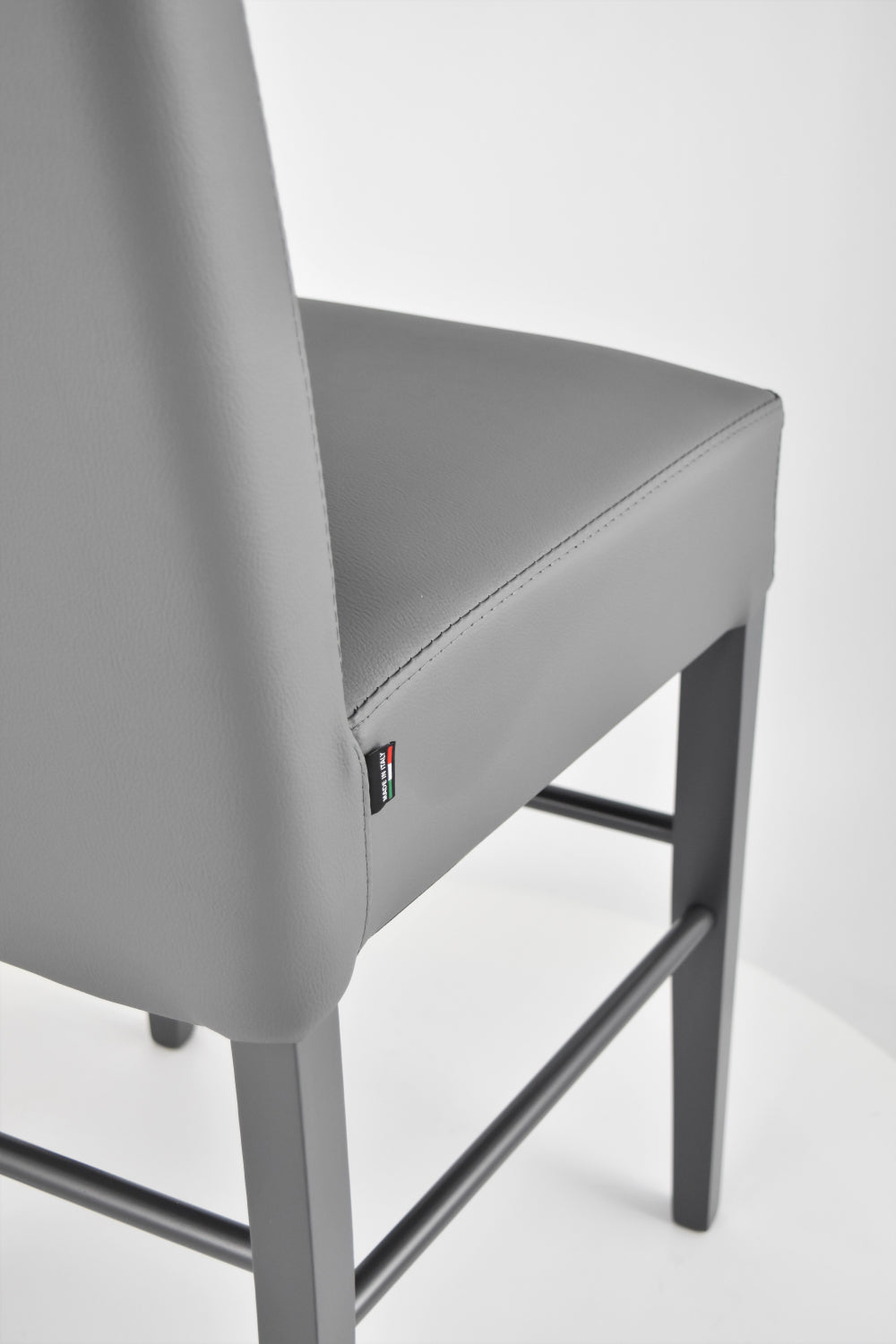 Luisa low stools in beech wood structure, padded seat and backrest covered in artificial leather
