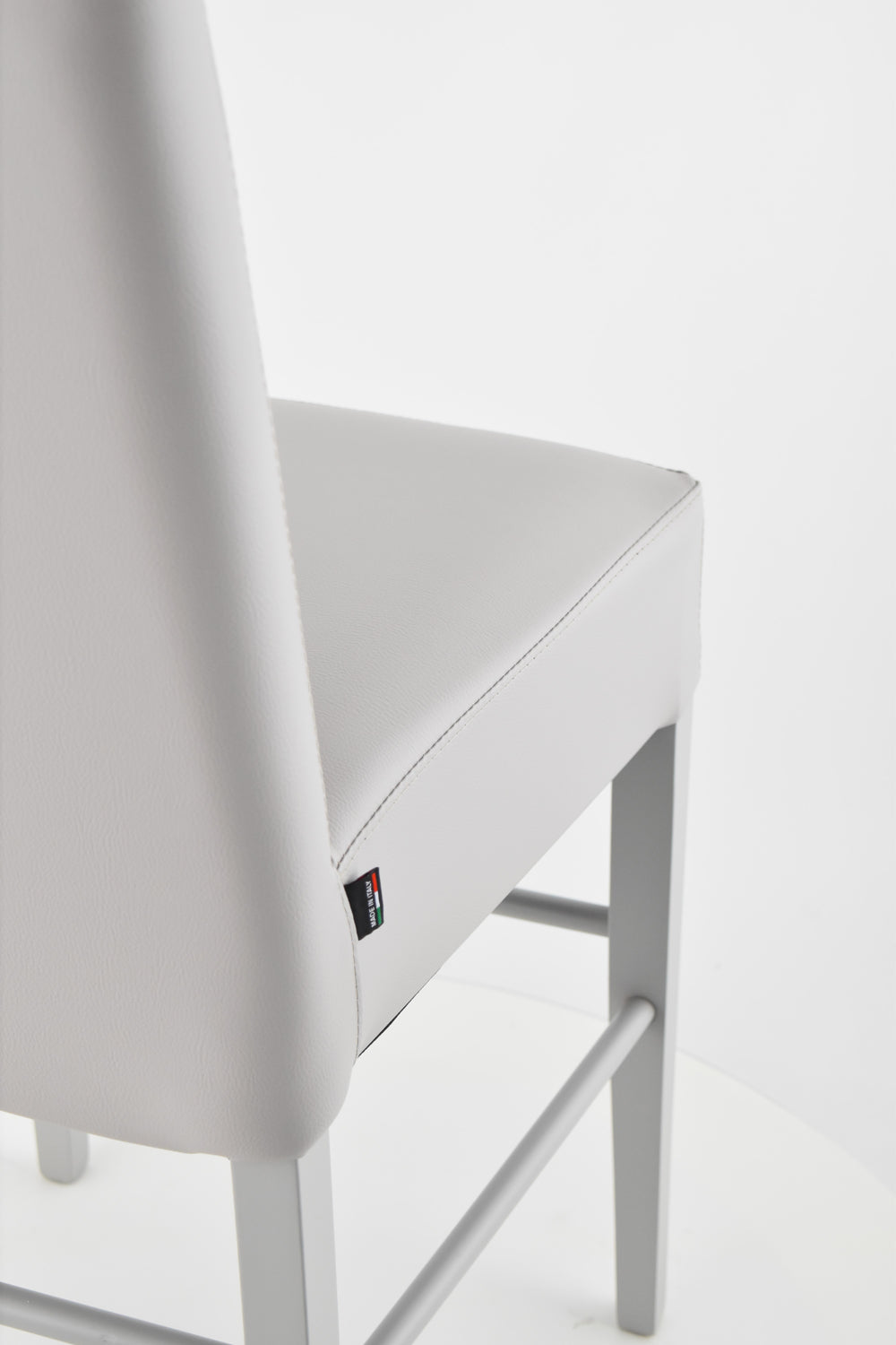 Luisa low stools in beech wood structure, padded seat and backrest covered in artificial leather
