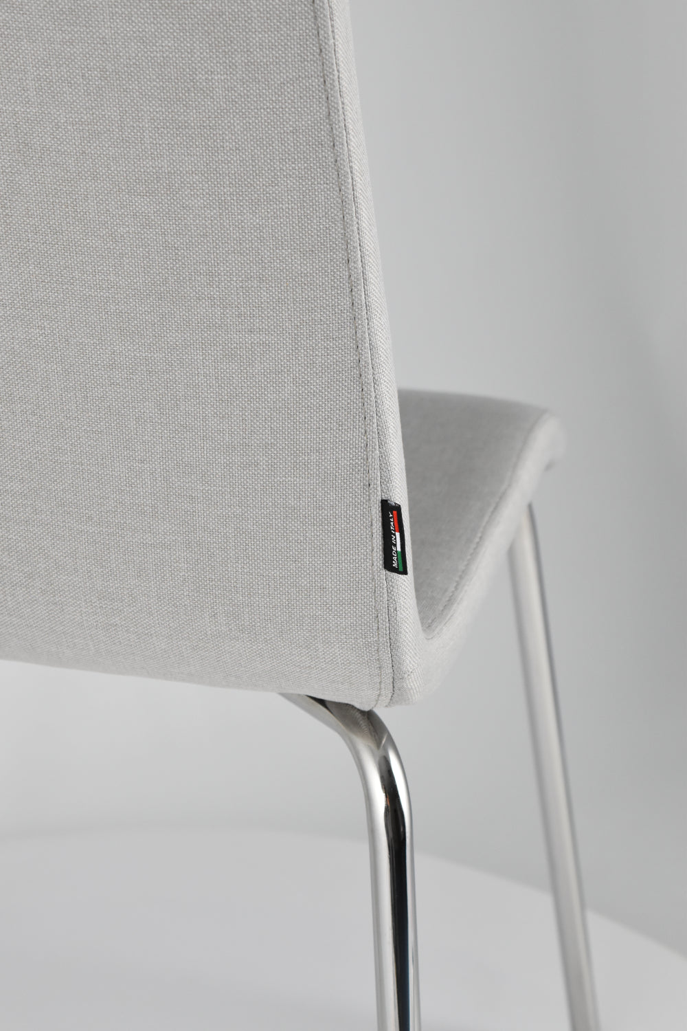 Chairs LISBONA with steel legs and seat in multilayer wood, upholstered in fabric colour pearl grey
